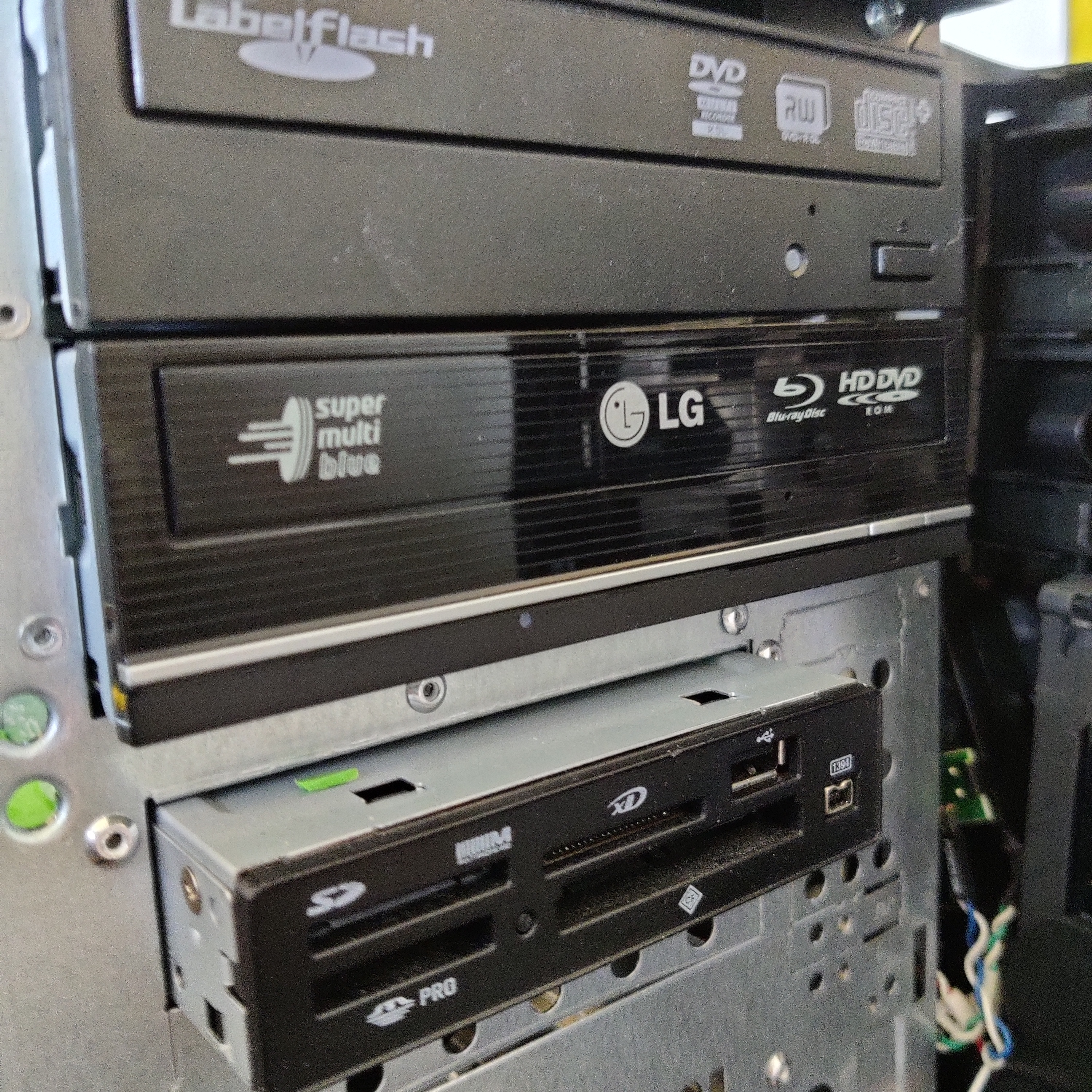 The optical drive installed into the case below an existing optical drive, just lacking the front panel