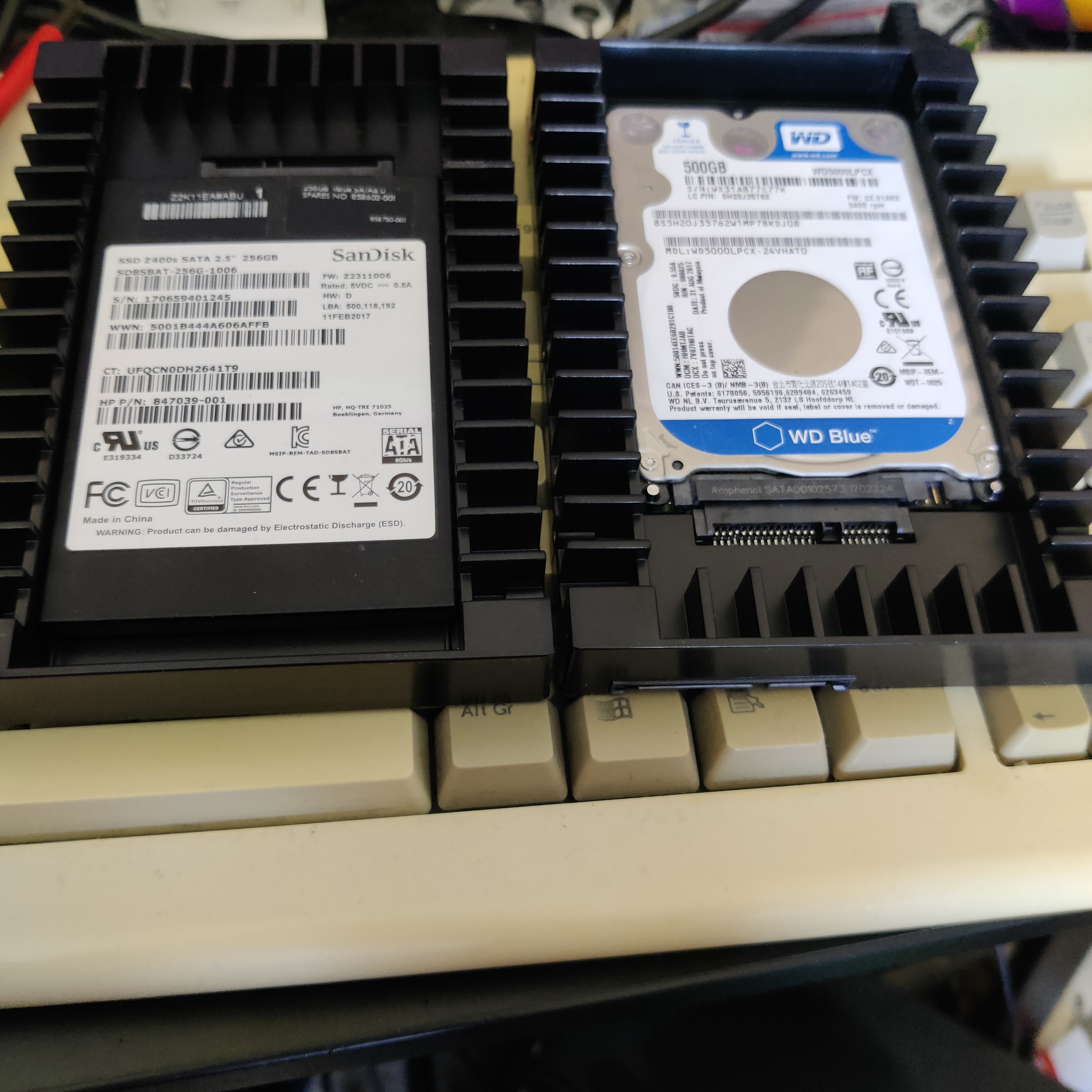 A photo of two  3.5 inch drives convert to 5.25 using an adaptor