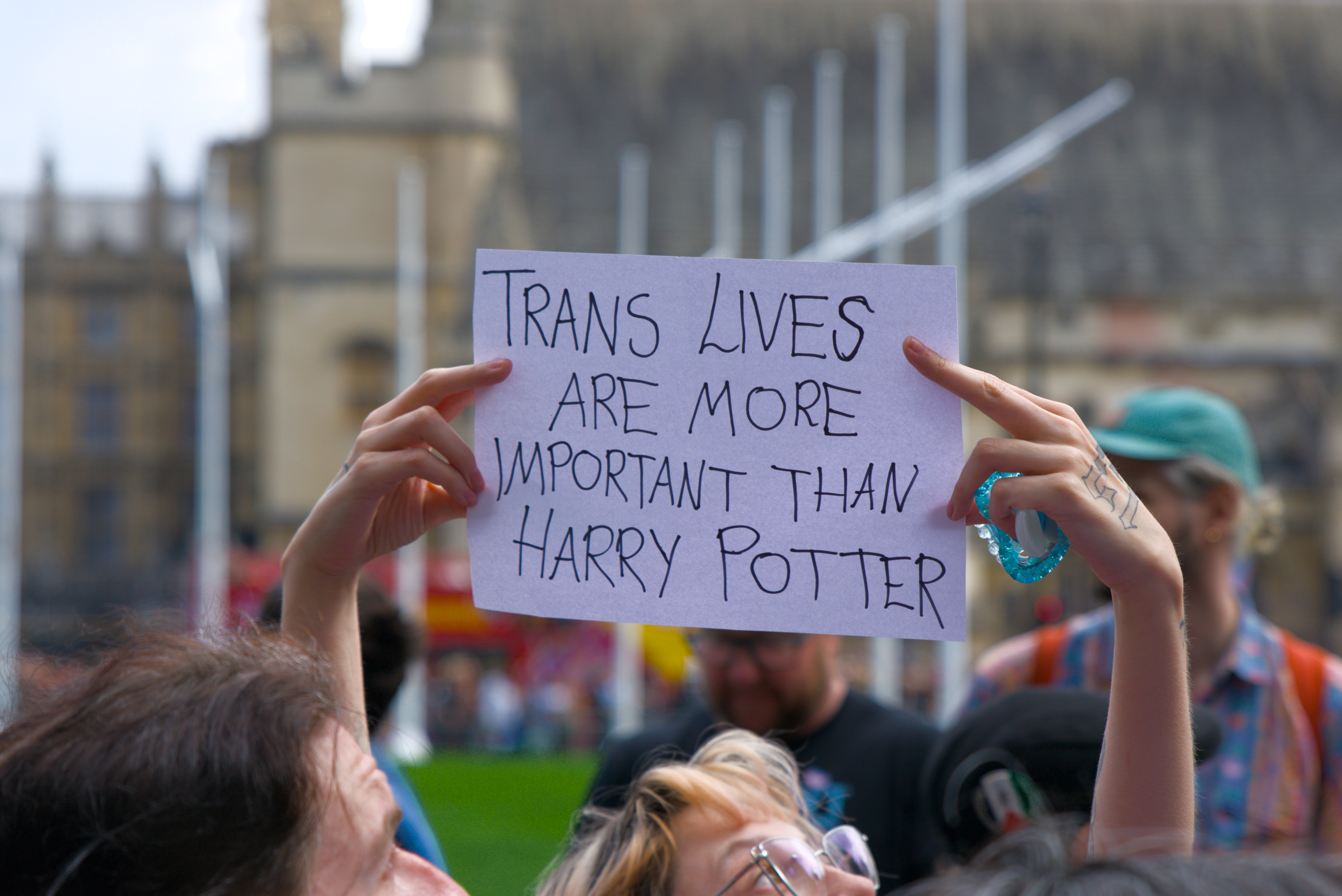 A picture of two hands holding up a banner that says 
